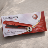 Remington Pro Keratin Therapy Pro Straightener packaging on a beige surface
