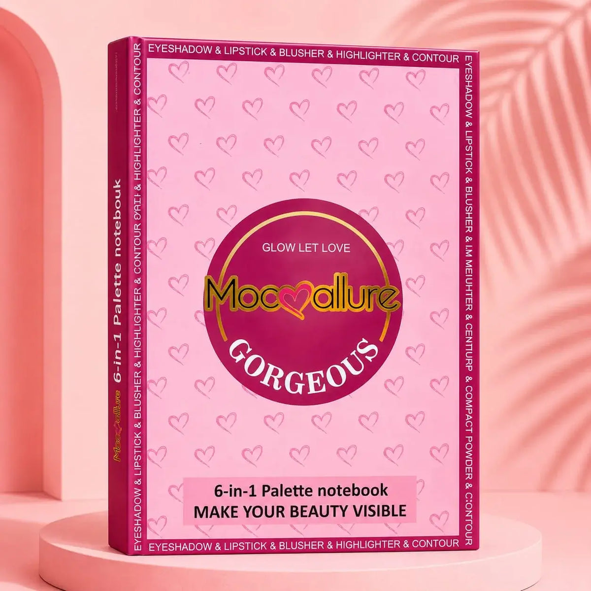 Mococulture Gorgeous 6-in-1 Palette notebook in a pink hardcover case, displayed on a pink pedestal against a pink background with a leaf silhouette.