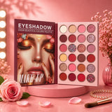 An open eyeshadow palette displayed on a pink pedestal, showing 18 shades from matte to shimmer, with the cover featuring a stylized face and the text 'EYESHADOW SHOW BEAUTIFUL COLORS PALETTE MAKE-UP'. The scene is styled in pink tones with flowers, a makeup brush, and warm light bulbs in the background.